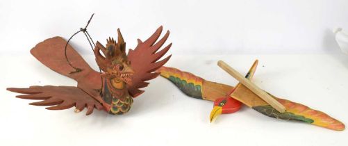 A Balinese carved wooden winged dragon together with a ceiling hanging carved wooden bird with
