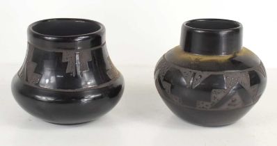 Two Mary Saxon, Navajo pottery vases, black glaze with decoration around the centre, signed to the