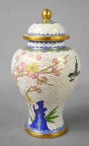 A Chinese cloisonne vase and cover, depicting prunus blossom and bird on a white ground, 17cm high.