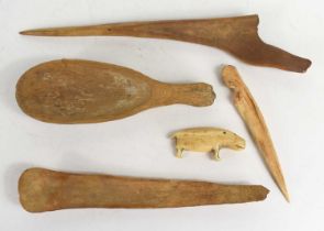 A 19th century Native American Inuit carved bone seal sculpture together with various bone tools and