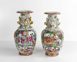 A pair of 19th century Cantonese porcelain vases of baluster form with trumpet necks, painted with