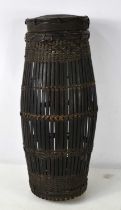 A hand woven bamboo and rattan container for storing locusts probably made by the Ifugao people,