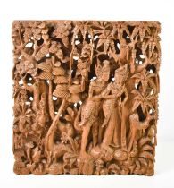 An intricate Balinese carving, depicting a courting couple in a forest, 37 by 34cm.