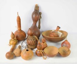 A collection of African and South American Calabash water containers, decorated with stylised