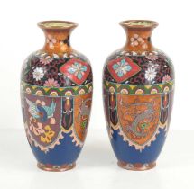 A pair of Chinese cloisonne vases decorated with flowers, bats and dragons, 18.5cm high.