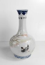 A 20th century Chinese bottle vase, in underglaze blue and white, and overglazed hand painted