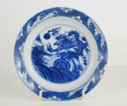 A 19th century Qing period blue and white Chinese dish, depicting a dragon chasing a flaming
