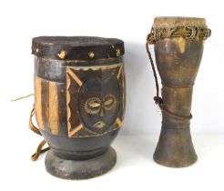 A vintage Indonesian hand drum, the top covered in animal hide, 46cm high, together with an