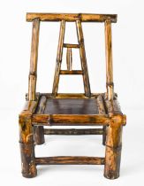 A Chinese miniature or child's chair, of bent and strut bamboo form, with sloped back, 29 by 20 by