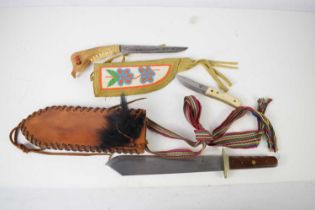 A Native American animal jaw handled knife with a beaded decorated sheath together with a large