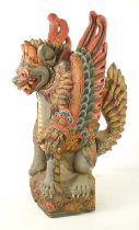 A Balinese polychrome and gilt wood sculpture of a winged lion, early 20th century, 59cm high.
