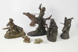 A group of resin and spelter sculptures to include a Native American on horseback, 33cm high.