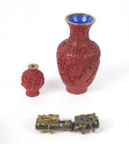 A small Chinese cinnabar snuff bottle, character mark to the base together with a enamel and