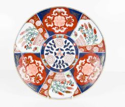 A 20th century Japanese Imari pattern plate with central decorated circular panel and fan shaped