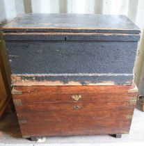 An antique wood and brass bound chest together with a painted pine trunk.