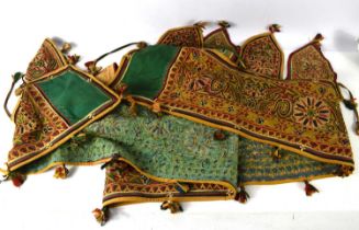 A North West Chinese or Tibetan linen pelmet hanging, of band and pennant form with polychrome