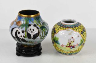 A Chinese cloisonne vase depicting pandas, raised on a wooden base, together with a ginger jar