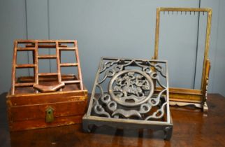 A Chinese book stand, the carved fretwork design with central roundel containing a mystical beast,
