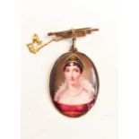 A delightful 19th century enamel portrait pendant / brooch, depicting a woman wearing a bejewelled