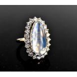 A large and impressive moonstone and diamond dress ring, the pear-cut cabouchon moonstone of