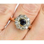 A gold, diamond and sapphire flowerhead ring, the brilliant cut sapphire 4mm diameter, surrounded by