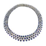 A stunning 18ct white gold, sapphire, and diamond résille collar necklace by Praquell, showcasing