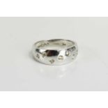 A 9ct white gold and diamond ring, the graduated swelling band, set with seven diamonds, size M, 3.
