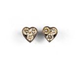 A pair of 18ct white gold and diamond earrings, of heart shape form each set with three diamonds,