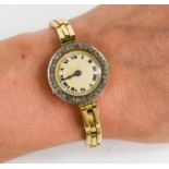 An 18ct gold and diamond ladies wristwatch, the circular Roman numeral dial set with a border of old