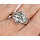 An 18ct white gold and diamond dress ring, with central quatrafoil cluster of four diamonds,