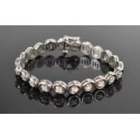 A 14ct white gold and diamond tennis bracelet, of twenty two circular framed panels, each with an