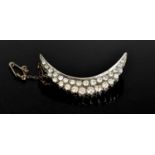 A 19th century white gold and diamond set crescent moon brooch, set with 28 brilliant cut diamonds