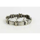 An 18ct white gold and diamond set bracelet, of eight long rectangular panels, each set with