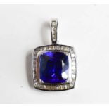 An 18ct white gold pendant set with large cushion cut tanzanite, surrounded by diamond brilliants,