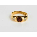An 18ct gold, garnet and diamond gentlemans ring, the diamonds 4mm diameter, the garnet 6mm