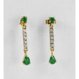 A pair of 14ct gold, diamond and emerald drop earrings, having pear shaped emerald drop to bar set