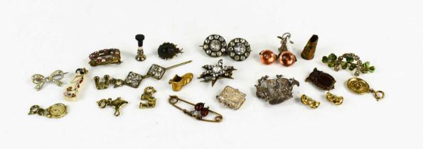 A selection of vintage jewellery and charms, to include silver filagree brooch in the form of a