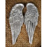 A pair of silvered plaster angel wings.