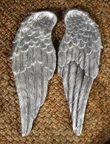 A pair of silvered plaster angel wings.