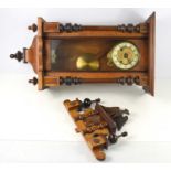 A 19th century mahogany cased Vienna style wall clock, with turned finials, the glass door opening