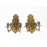 A pair of gilt metal French 19th century wall sconces, the cast embossed backplates emanating twin