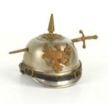 WW1 Trench Art: An inkwell made in the form of a German soldiers Pickelhaube helmet.