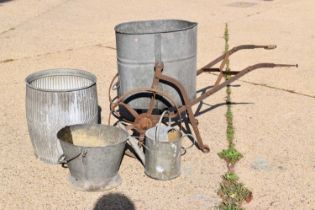 A galvanised water carrier on a cast iron frame together with galvanised bucket, watering can and