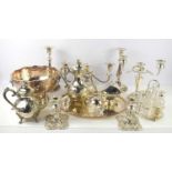 A collection of silver plated items to include candelabra, punch bowl, tea and coffee pot,