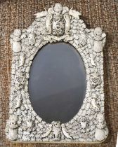 An impressive 19th century French Dieppe bone carved mirror, possibly made by a prisoner of war, the