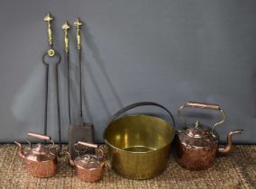 A 19th century brass jam pan together with three copper kettles and a fireside companion set,