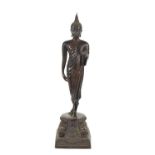 A late 19th / early 20th century bronzed metal Thai Buddha figure, raised on a decoratively cast