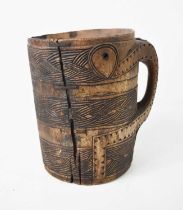 A 19th century treen tankard of large proportions, possibly Norwegian, carved with ropetwist