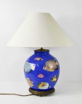 A blue glass lamp base depicting tropical fish, with a large 28 inch cream shade, 63cm high.