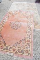 Two Chinese wool rugs, in pastel shades, both with foliate scroll borders, 183cm by 270cm and